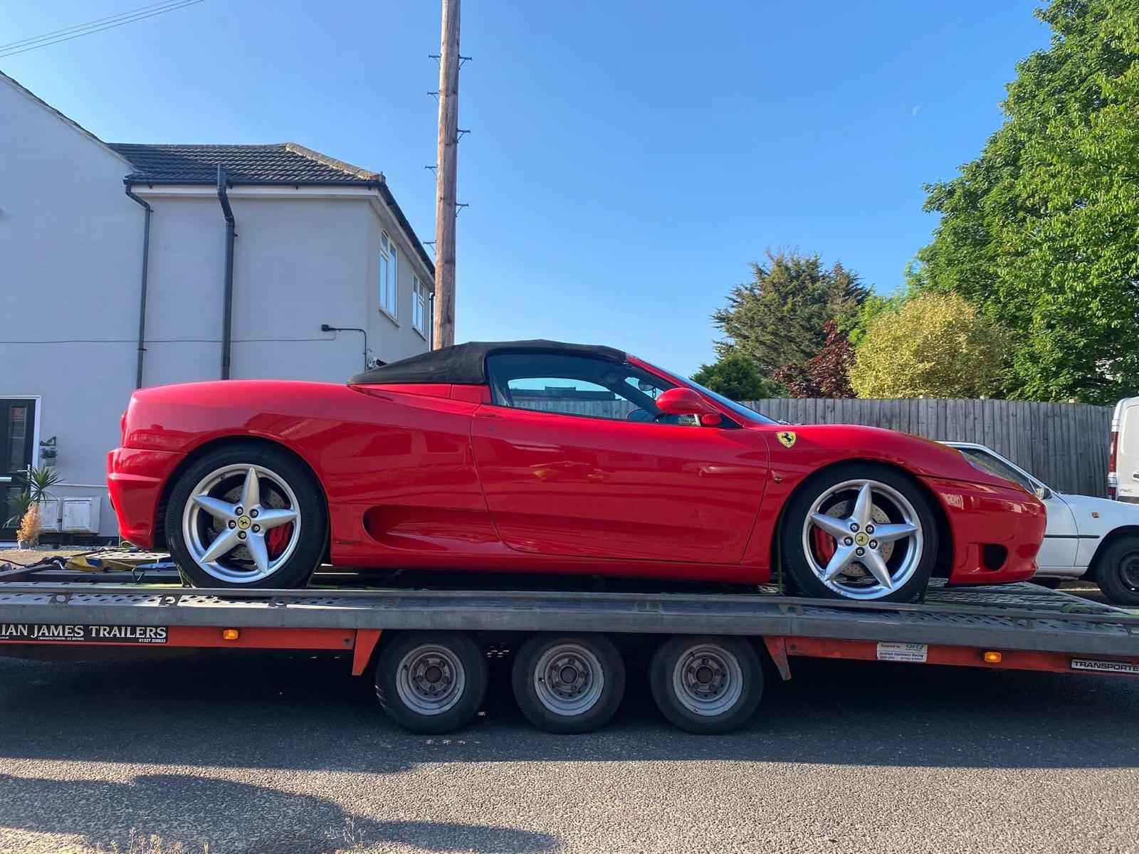 Red Ferrari on a car transport trailer